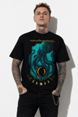 Modelo masculino con tatuajes usando playera negra de A Perfect Circle con diseño de pulpo azul.